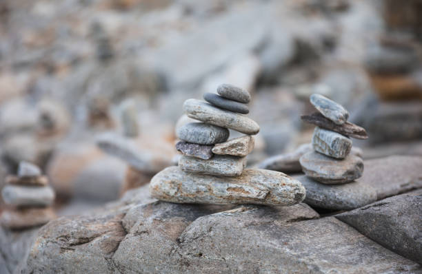 istock serene beach scene with smooth rocks stacked in a balanced formation. The tranquil atmosphere evokes a sense of zen, harmony, and peace, symbolizing balance and mindfulness in nature 2172463020