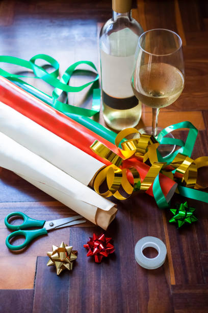 istock White wine bottle with glass and gift wrapping materials. 2172464012