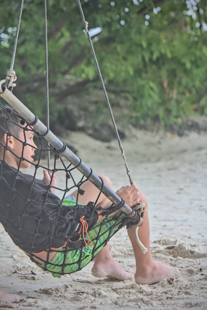 istock Boy relaxing on a swing chair 2172464369