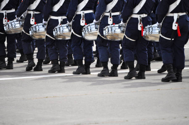 Uniformed people in a row with drums