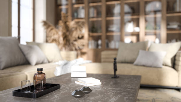 A luxury marble coffee table, poufs, and a houseplant near by the window in a modern white living room. 3d render, 3d illustration