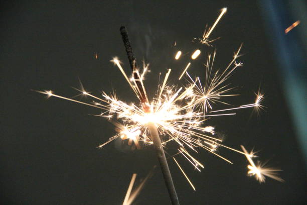 istock A close-up view of a sparkler igniting with bright sparks in a darkened environment during nighttime celebrations 2172476599