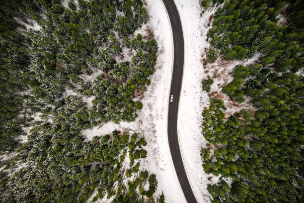 istock Flight over the winter mountains with road serpentine 2172477593