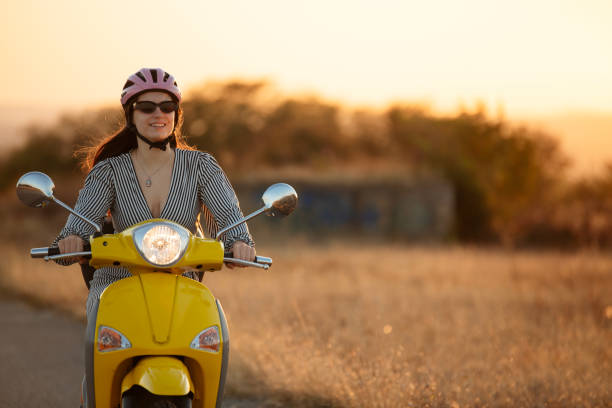 istock Young female driving a yellow sooter at sunset. 2172480415