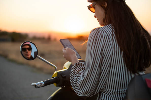 istock Young woman on a scooter using her phone. 2172480428