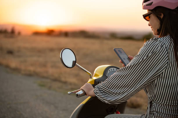 istock Young woman on a scooter using her phone. 2172480441