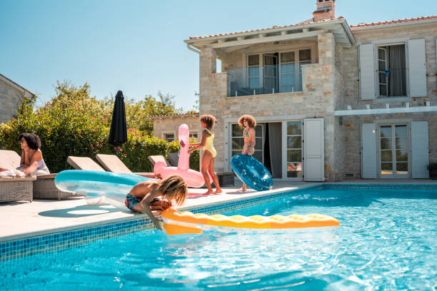 istock Young Mixed Race Siblings in Swimwear Having Fun with Floaties 2172483219