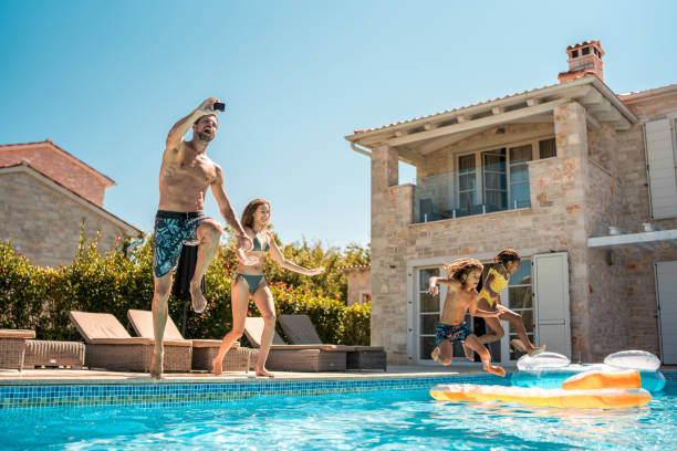 istock Mixed Race Kids and Caucasian Father Having Fun at Pool 2172483238