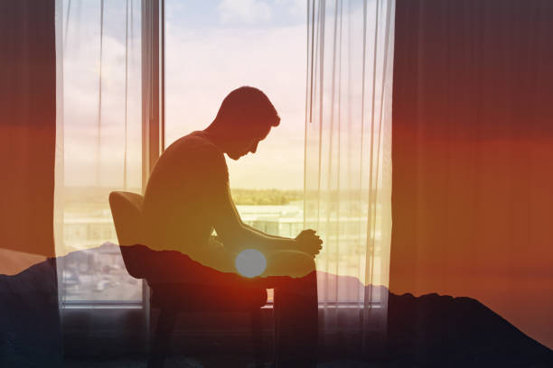 Very sad man sitting in a dark room
