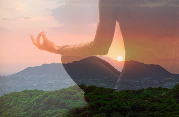 istock Woman meditating at sunset. 2172484408