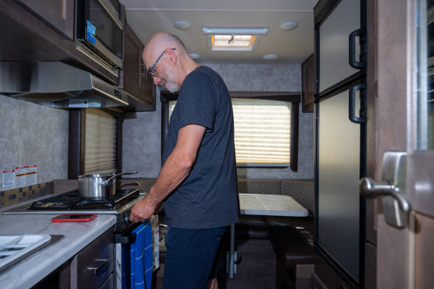 istock Mature man cooking inside motorhome 2172485876