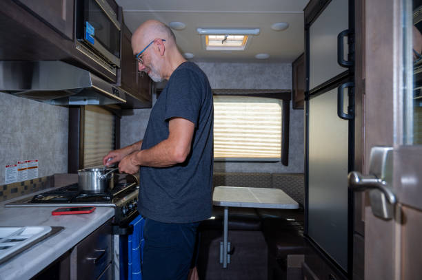 istock Mature man cooking inside motorhome 2172485894