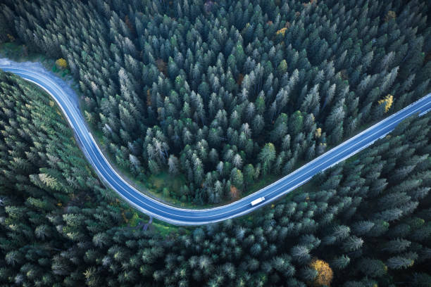 istock Flight over the autumn mountains with road serpentine 2172487531