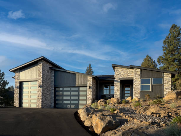A Contemporary house adjacent to tree-lined sidewalk and grassy lawn