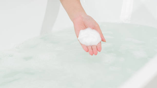 istock Photoshoot featuring model performing self-care actions in a bathroom 2172490587