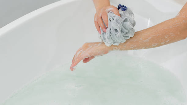 istock Photoshoot featuring model performing self-care actions in a bathroom 2172490608