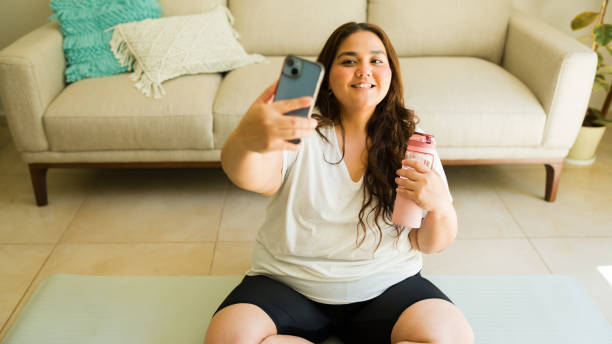 istock Joyful curvy woman snaps a selfie with a protein shake post workout at home 2172495761