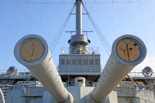 Shot of the battleship USS Alabama, docked in Mobile, AL, taken from just in front of the main guns. Focus is on the tip of the middle gun barrel.