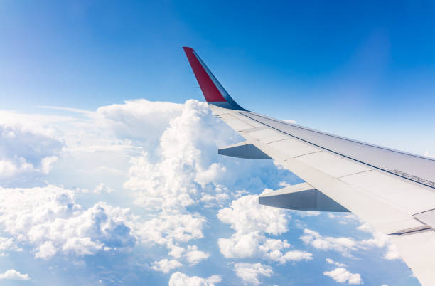 istock View from the airplane window at a beautiful cloudy sky and the airplane wing 2172502736