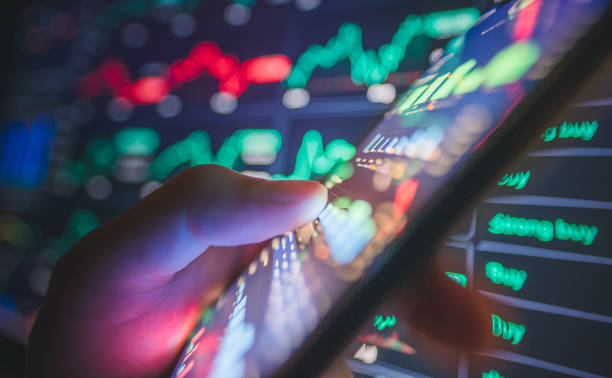 istock Hand using online trading charts and graphs for gold and silver, showcasing the financial world’s reliance on technology and real-time updates forinvestment decisions 2172505680