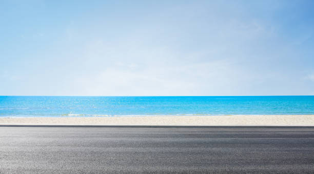 istock Empty asphalt road near beach under clear blue sky 2172509837