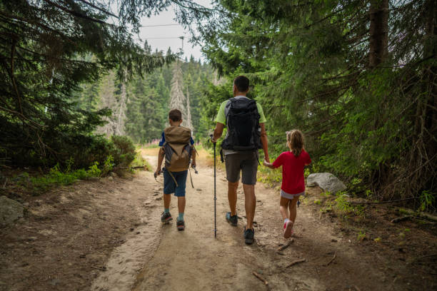 istock Happy family hiking in pine forest 2172514135