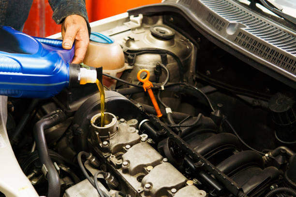 istock A man is pouring oil into a car engine 2172514433