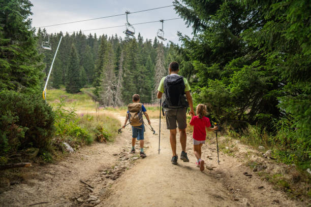 istock Happy family hiking in pine forest 2172514576