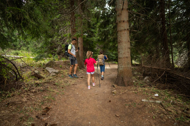 istock Happy family hiking in pine forest 2172514648