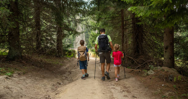 istock Happy family hiking in pine forest 2172514928