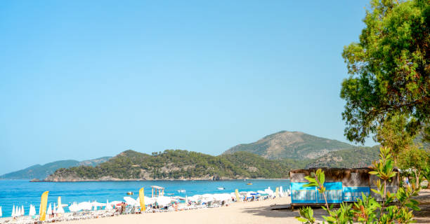 istock Beach View with Sun Loungers and Bars Along the Shoreline 2172519945