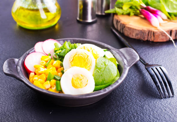 A bowl of ramen with boiled egg, corns, spinach, and radish, diet food