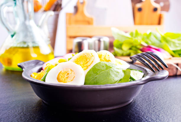 A bowl of ramen with boiled egg, corns, spinach, and radish, diet food