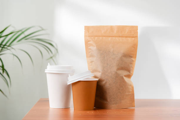 istock Three beverage containers and a paper bag on a wooden table 2172522763