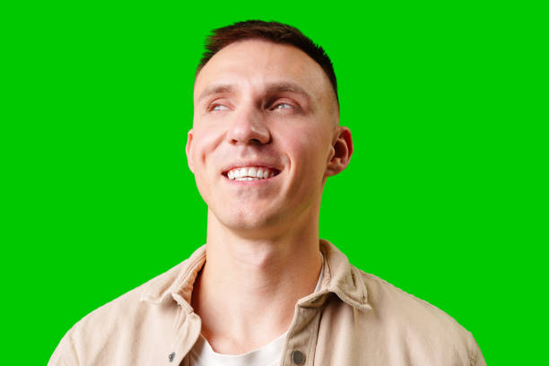 istock Smiling Man With Short Hair Posing Against Bright Green Backdrop 2172522767