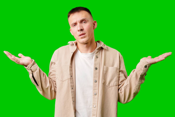 istock Young Man With Neutral Expression Shrugging His Shoulders Against Bright Green Background 2172523675