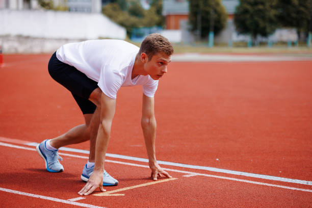 istock Male athlete in starting position on running track 2172523701