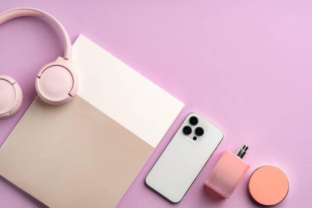 istock Colorful accessories and a smartphone arranged stylishly on a pastel pink surface 2172525442