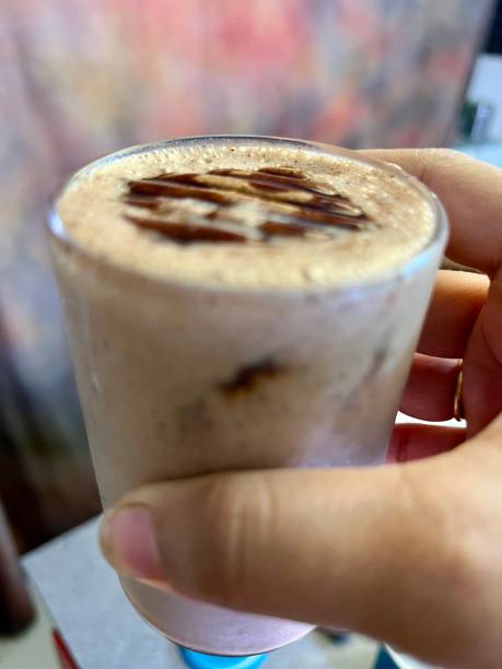 istock cookie shake glass in a women's hand garnished with chocolate bisket. 2172528498