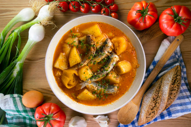 istock Sardine stew with potatoes and leeks. Top view table with  decorations. 2172529505
