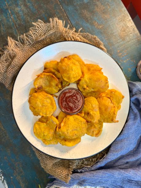 istock An Indian snack pakora with sauce on Textile background with blue table view. 2172530037