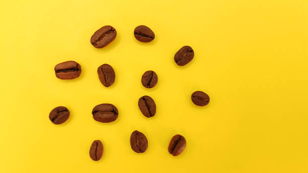 istock Natural roasted coffee beans on a sunny yellow background 2172530398