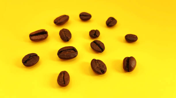 istock Natural roasted coffee beans on a sunny yellow background 2172530405