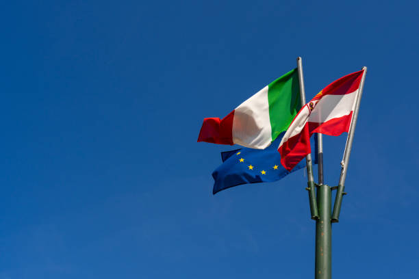 istock Italian Austrian and EU flags waving in clear sky 2172534682