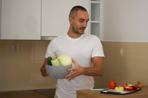 istock Young man making delicious food in kitchen 2172534815