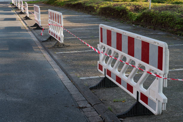 istock Temporary road closure barriers line an unused parking area 2172534837