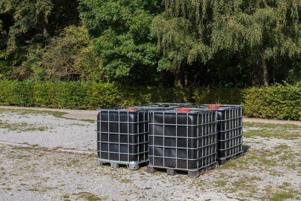 istock Black storage containers placed on a gravel surface near greenery 2172536479