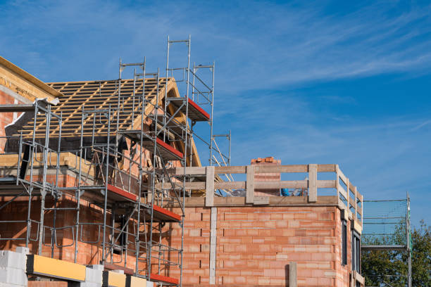istock Construction site with scaffolding and brick walls under clear sky 2172536890