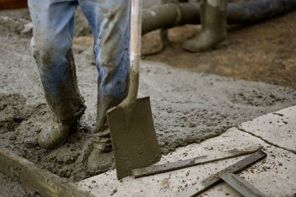 istock Road crew pours fresh concrete on roadway 2172537338