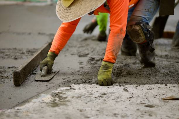 istock Road crew uses hand trowel to finish concrete 2172537595